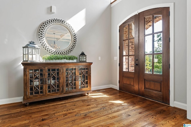 entryway with french doors, a chandelier, and hardwood / wood-style flooring