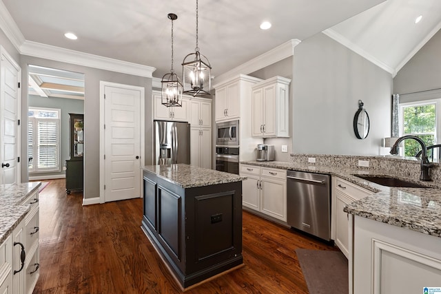 kitchen featuring sink, a kitchen island, white cabinets, and appliances with stainless steel finishes