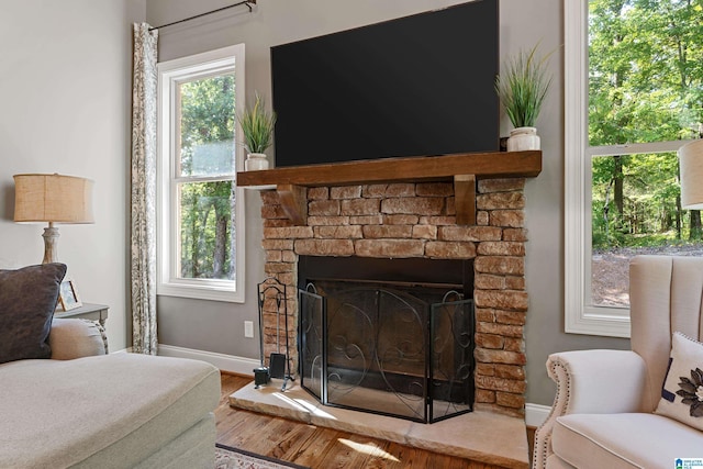 bedroom with hardwood / wood-style floors and a fireplace