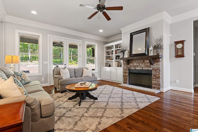 living room with dark wood-type flooring, ornamental molding, and french doors