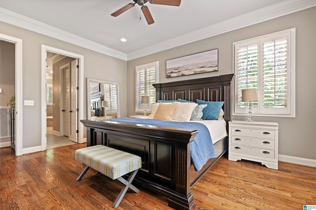 bedroom with multiple windows, ornamental molding, ceiling fan, and light hardwood / wood-style flooring