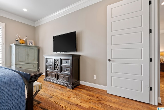 bedroom with light hardwood / wood-style flooring and ornamental molding