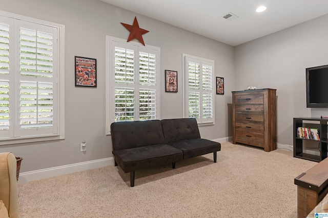 living area with light carpet