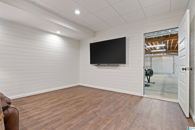 living room with hardwood / wood-style floors and a drop ceiling