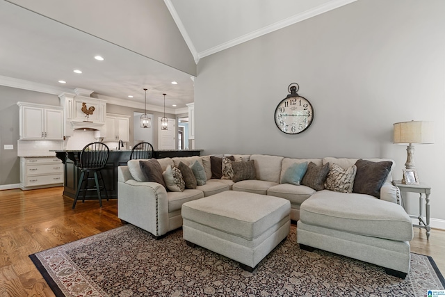 living room with ornamental molding, vaulted ceiling, and dark hardwood / wood-style floors