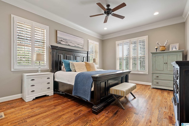 bedroom with light hardwood / wood-style flooring, ornamental molding, and ceiling fan