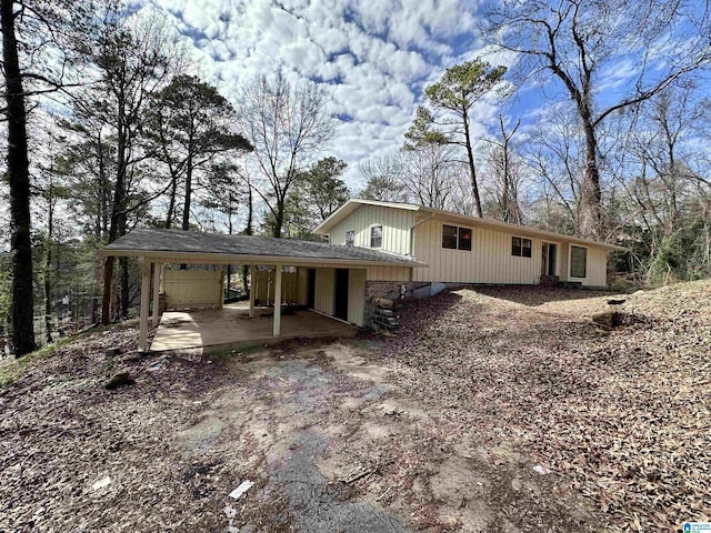 rear view of property featuring a carport