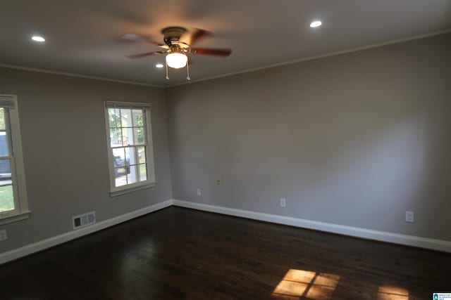 unfurnished room featuring crown molding, dark wood-type flooring, and ceiling fan