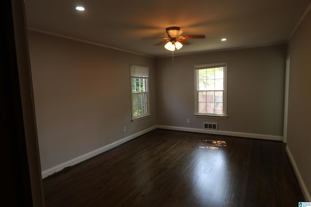 spare room featuring dark hardwood / wood-style flooring, crown molding, and ceiling fan