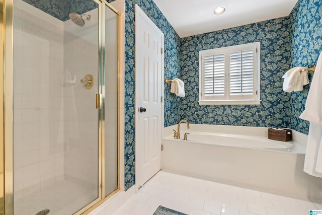 bathroom with separate shower and tub and tile patterned flooring