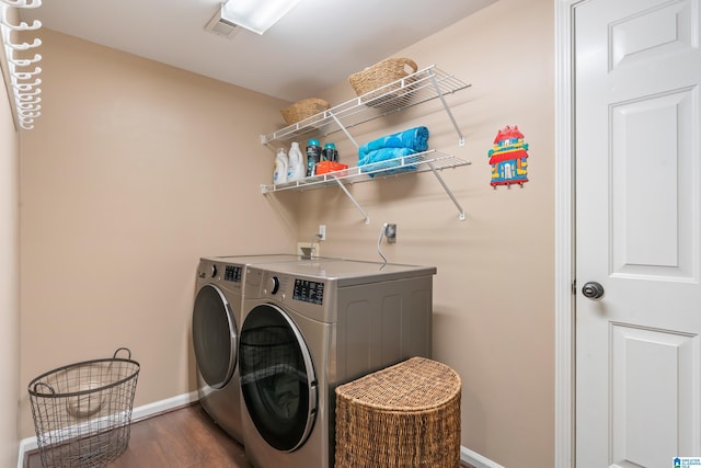 laundry room featuring independent washer and dryer and dark hardwood / wood-style floors