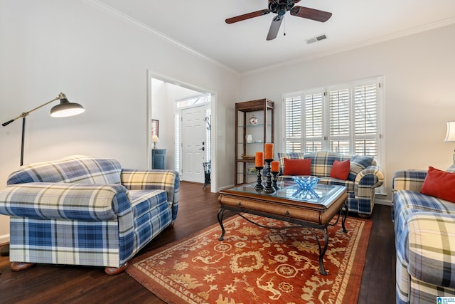 living room featuring dark wood-type flooring, crown molding, and ceiling fan