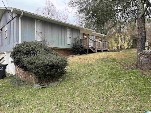 view of front of home with a deck and a front yard