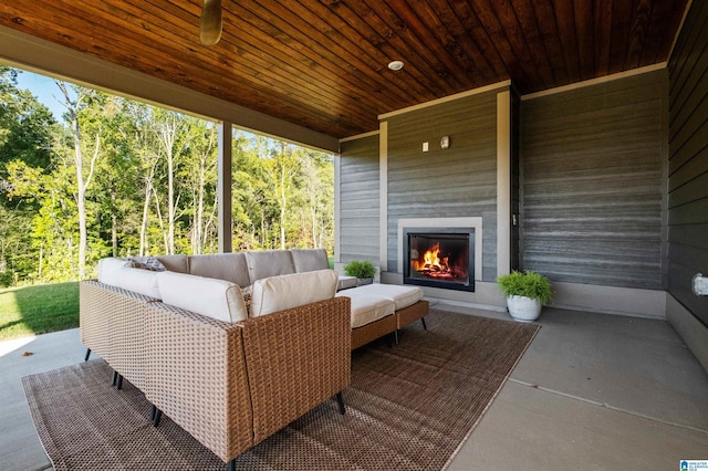 view of patio / terrace with an outdoor living space with a fireplace