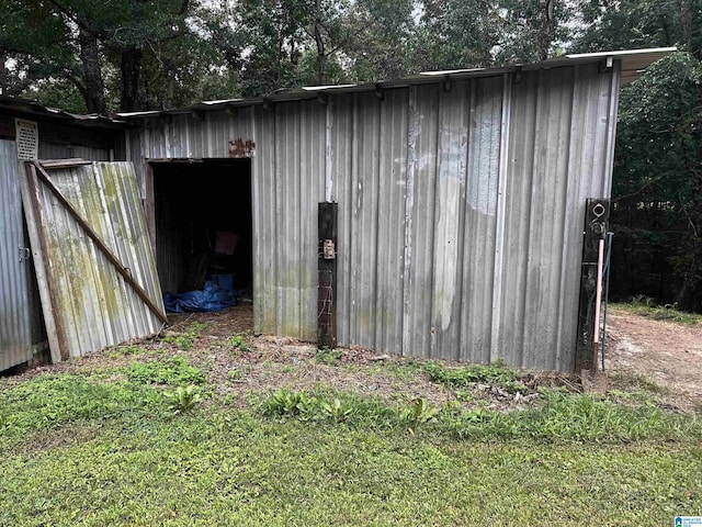 view of outdoor structure with a lawn