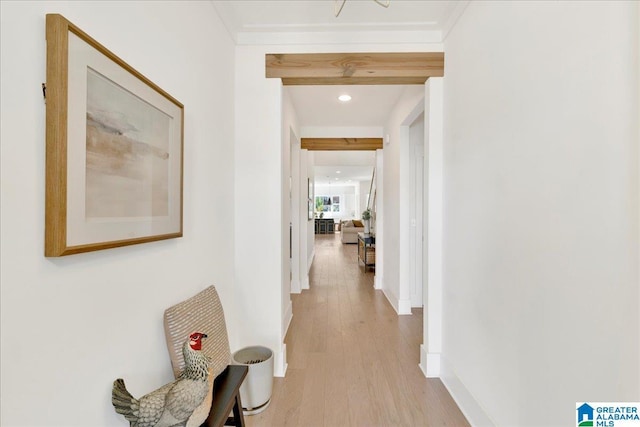 hallway with light wood-style flooring and baseboards