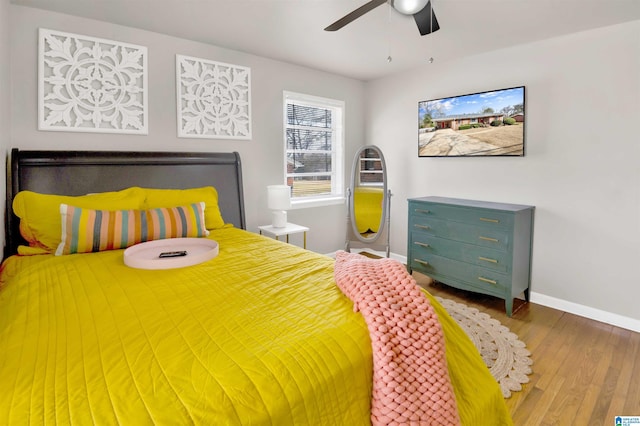 bedroom with hardwood / wood-style floors and ceiling fan