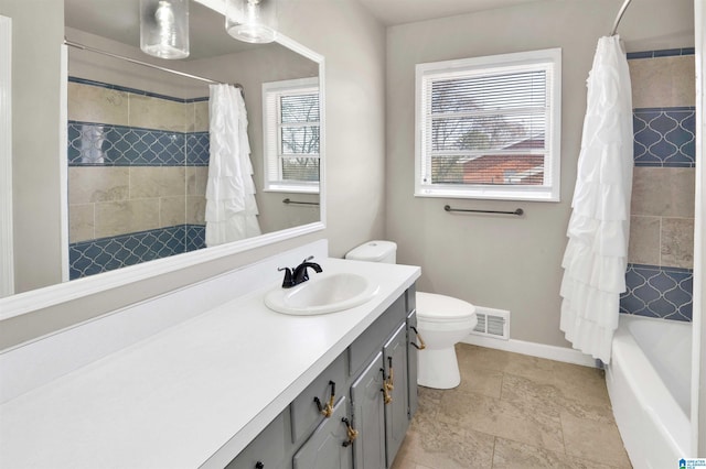 full bathroom featuring toilet, vanity, and shower / tub combo