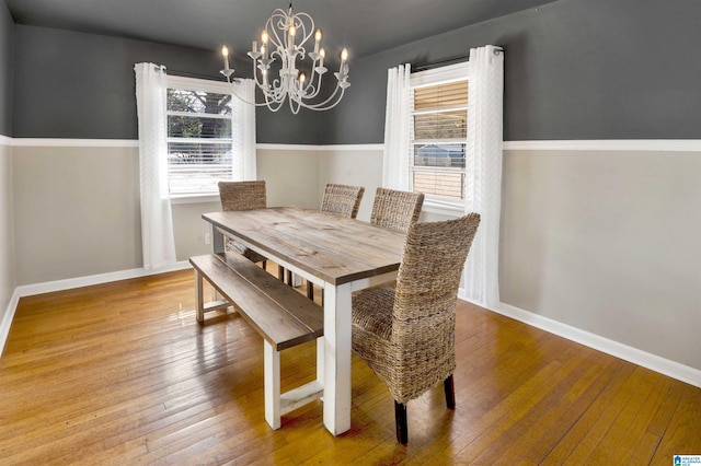 dining room featuring hardwood / wood-style floors and a chandelier