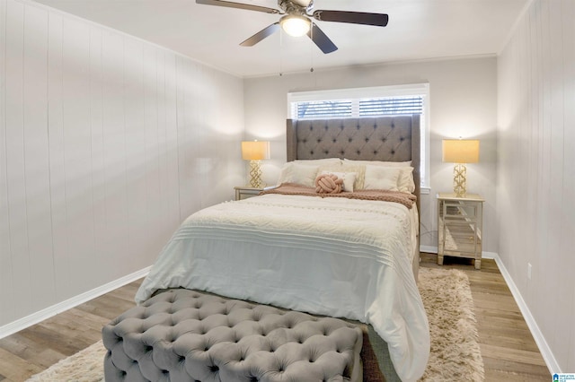 bedroom featuring crown molding, ceiling fan, and light hardwood / wood-style flooring