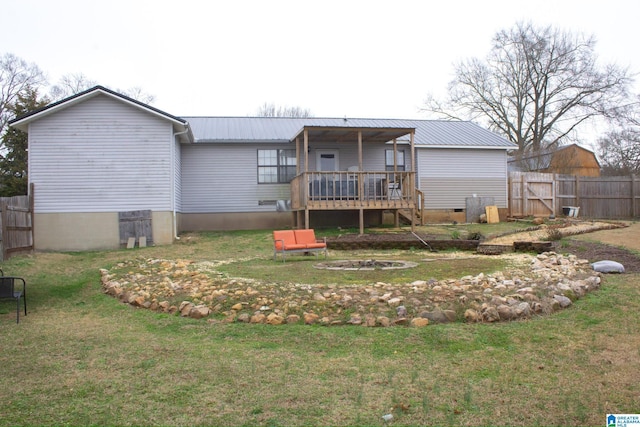 1536 Buckelew Bridge Rd, Anniston, AL 36207 - rear view of house with metal roof, crawl space, fence, a deck, and a yard