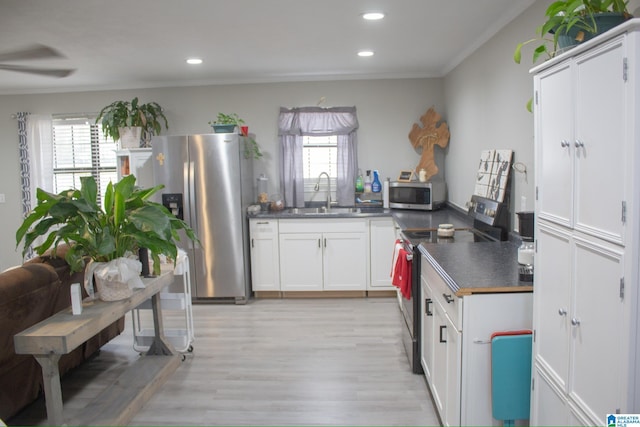1536 Buckelew Bridge Rd, Anniston, AL 36207 - kitchen featuring dark countertops, white cabinetry, stainless steel appliances, and a sink