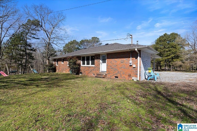 back of property featuring entry steps, crawl space, a yard, a playground, and brick siding