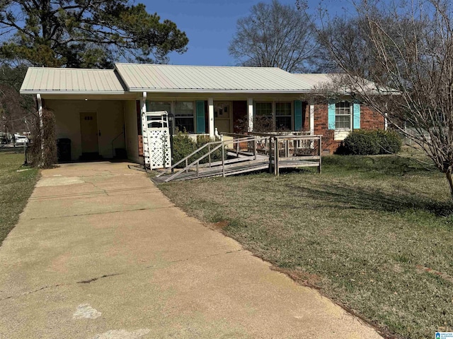 single story home featuring a carport and a front yard