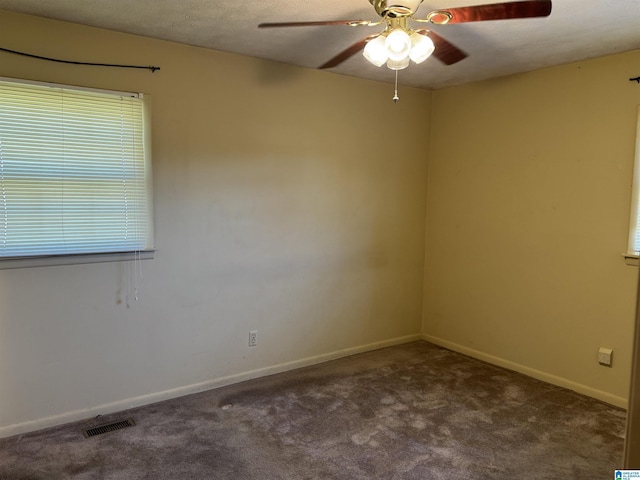 unfurnished room with a textured ceiling, carpet floors, and ceiling fan