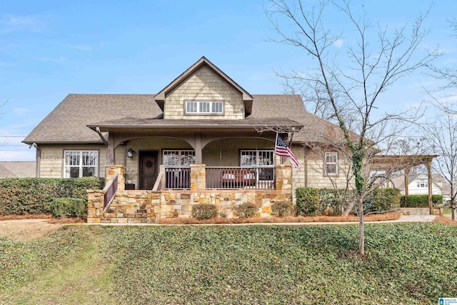 craftsman house featuring a porch and a front yard