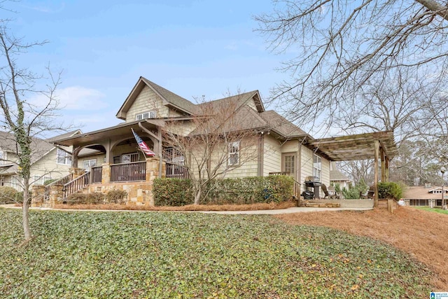 view of property exterior with covered porch and a yard