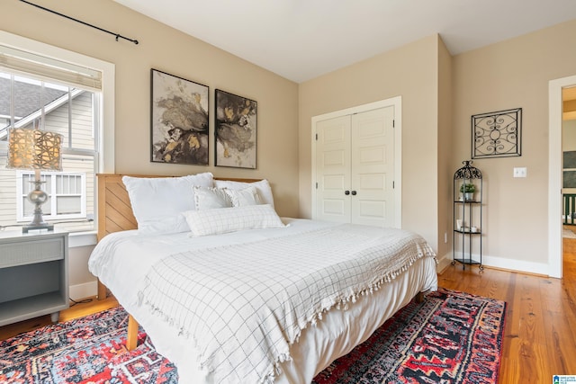 bedroom featuring wood-type flooring and a closet