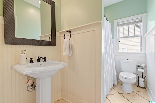 bathroom with tile patterned flooring and toilet