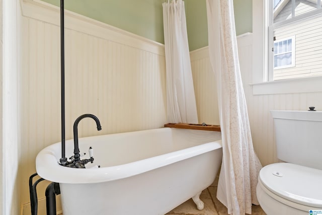 bathroom featuring toilet and a bathing tub