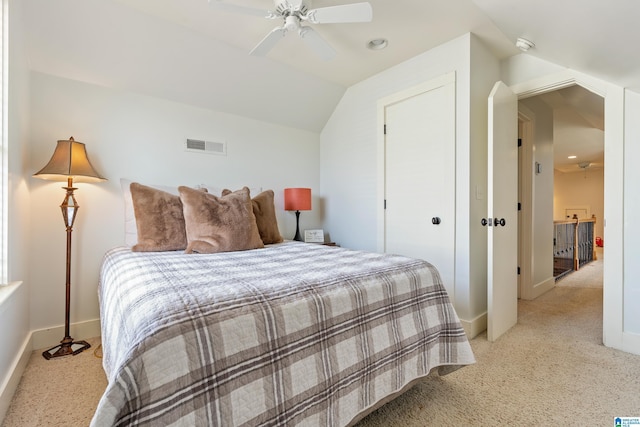 carpeted bedroom with vaulted ceiling and ceiling fan