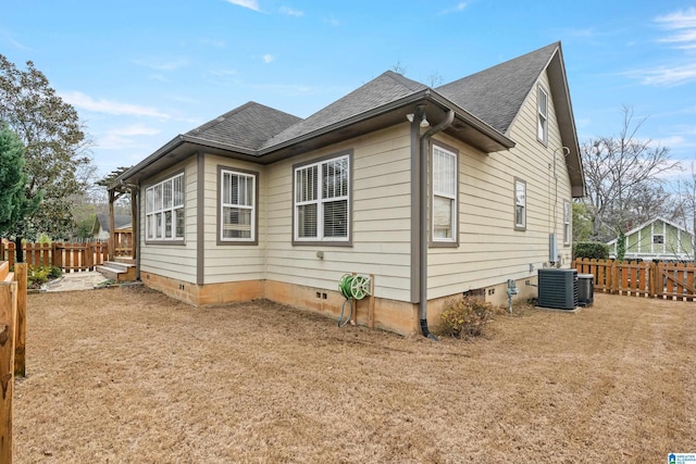 view of side of property featuring central AC