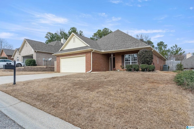 view of front of house with cooling unit, a garage, and a front lawn