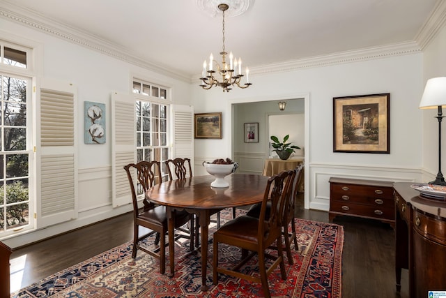 dining room featuring a healthy amount of sunlight, a chandelier, and dark wood-style flooring