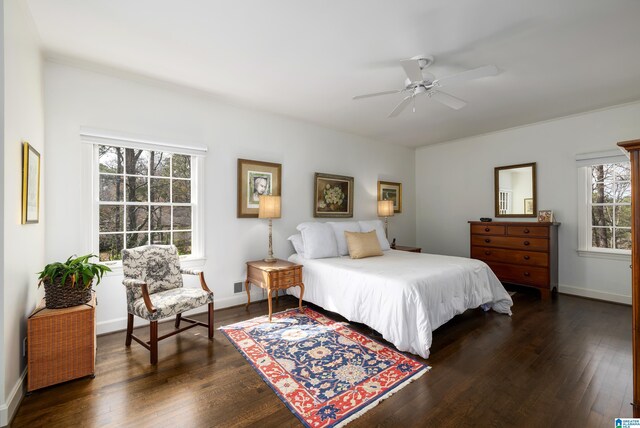 bedroom featuring a ceiling fan, dark wood-style flooring, and baseboards