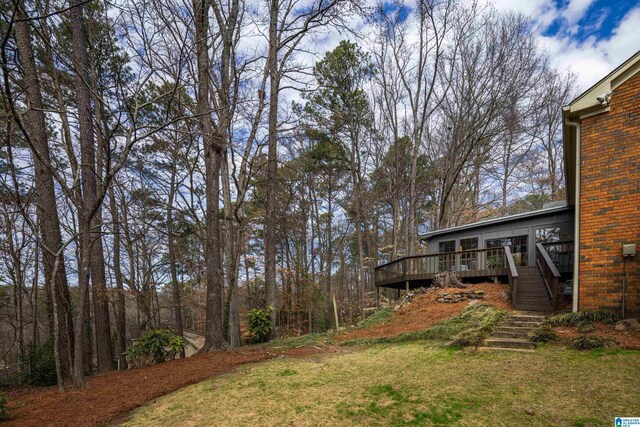 view of yard featuring a deck and stairs