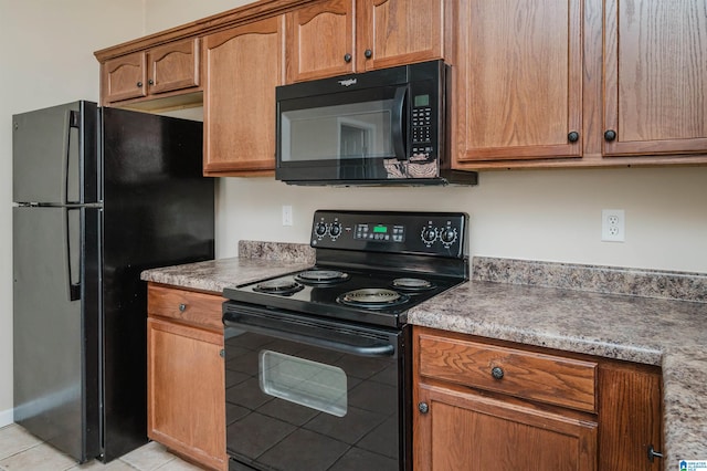 kitchen featuring light tile patterned floors and black appliances