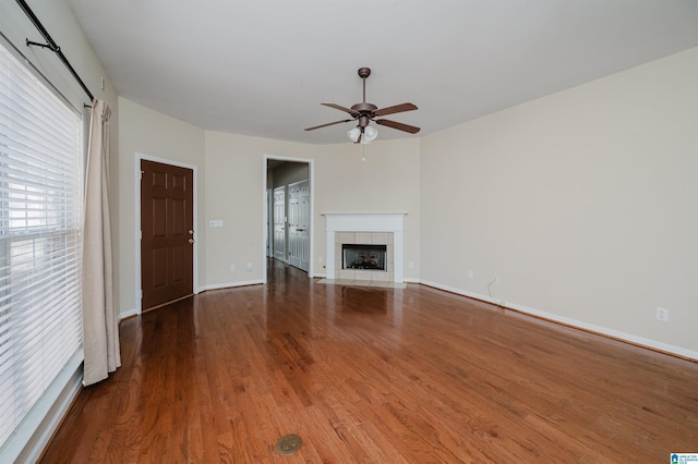 unfurnished living room featuring a fireplace, ceiling fan, and hardwood / wood-style flooring