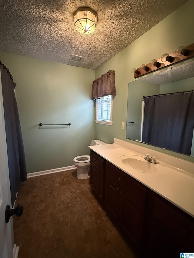 bathroom with baseboards, visible vents, toilet, a textured ceiling, and vanity