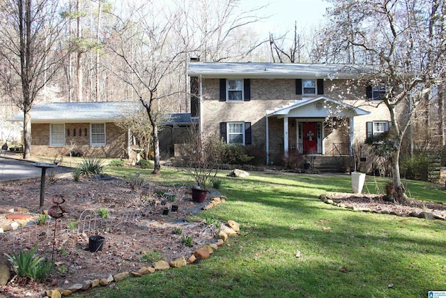 traditional-style house featuring a front lawn and brick siding