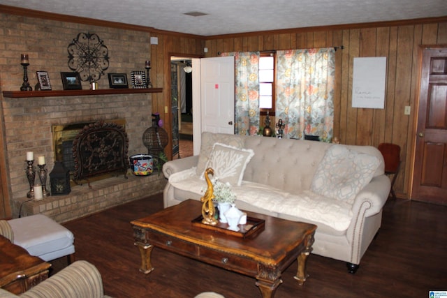 living room with wood walls, crown molding, a textured ceiling, and wood finished floors