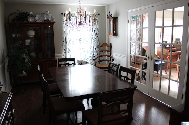 dining room with a notable chandelier, dark wood-style flooring, and french doors