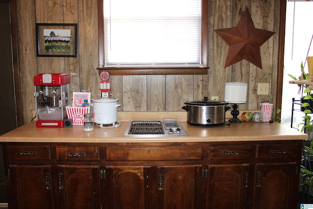 kitchen with stainless steel gas cooktop, light countertops, and dark brown cabinetry