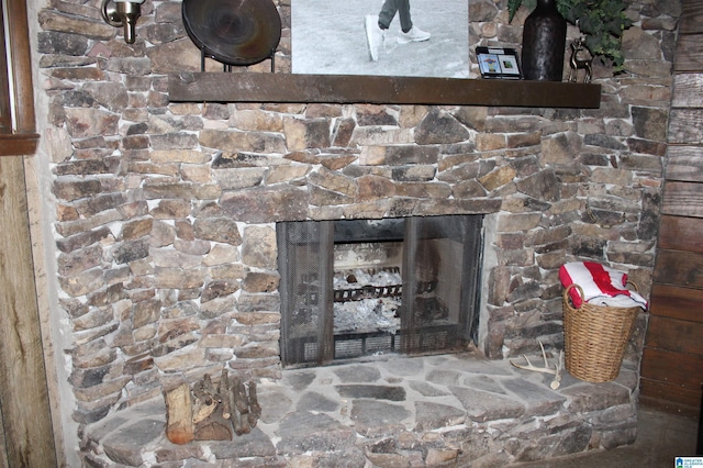 interior details featuring a stone fireplace