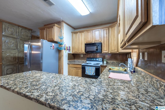 kitchen featuring stone countertops, black appliances, sink, kitchen peninsula, and a textured ceiling