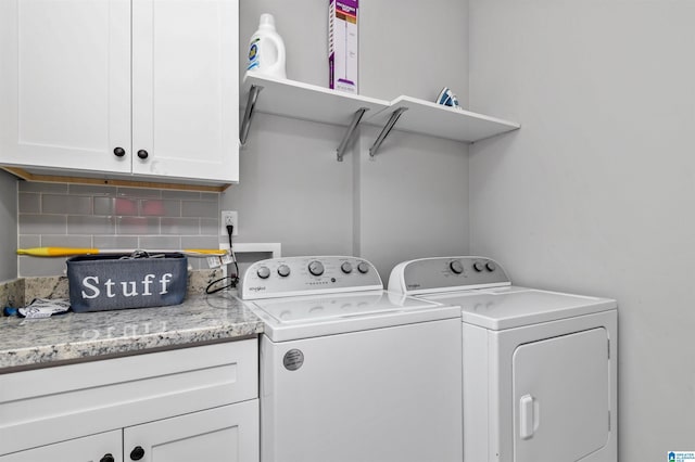 clothes washing area with cabinets and washer and dryer